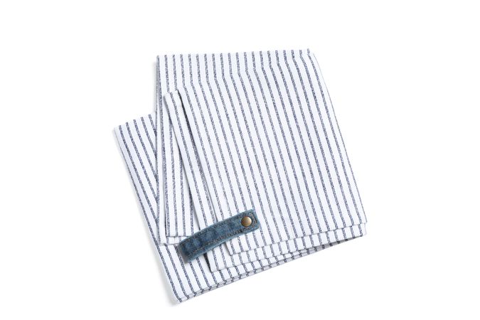 Folded fabric napkin isolated on plain background