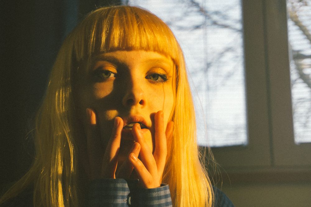 Portrait of blonde woman with bangs  indoor