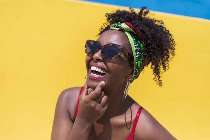 Portrait of smiling Black woman against yellow wall