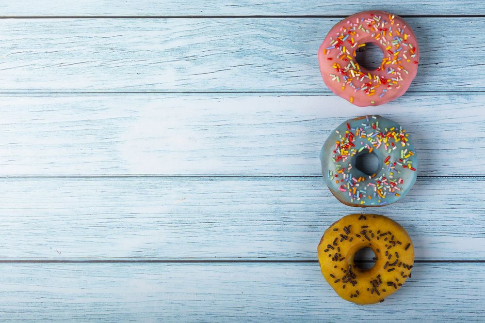 Delicious assorted colorful donuts on the table.