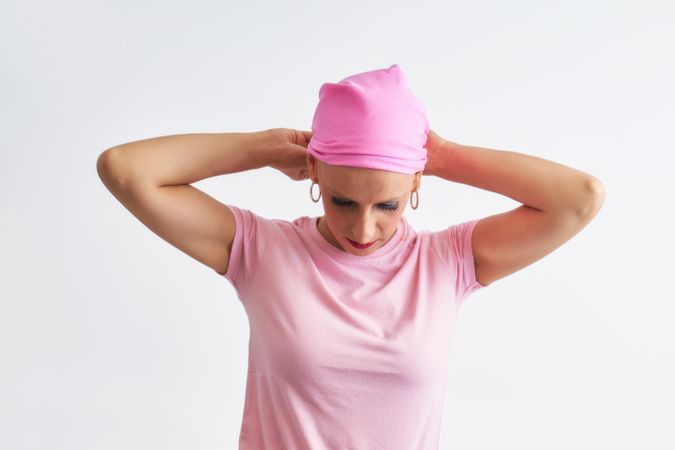 a woman suffering from cancer wearing a pink scarf