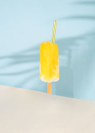 Ice cream pop with party cocktail straw.
