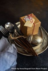 Christmas table setting with silver ware and gift box bY8M64