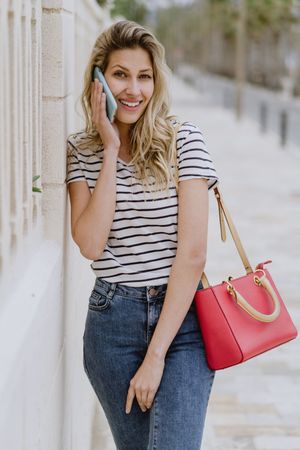 Woman using phone on city street