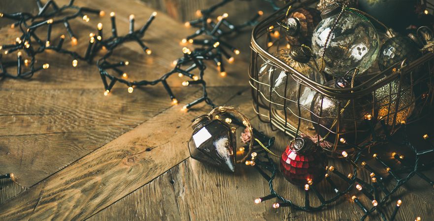Christmas tree decorations, with garland, on wooden counter, copy space, wide composition