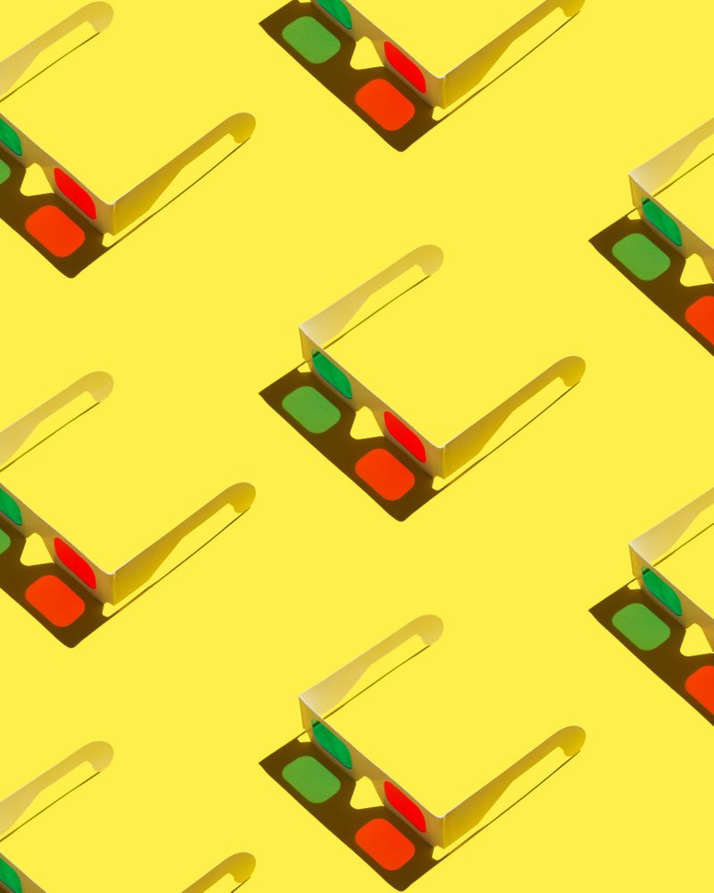 3D glasses and shadows on yellow background