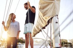 Couple standing and smiling on a boat
