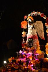 Paper Mache angel sculpture at atlar at Day of the Dead celebration at night