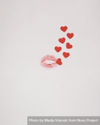 Kiss with small red hearts coming out of it on a plain background 41wd80