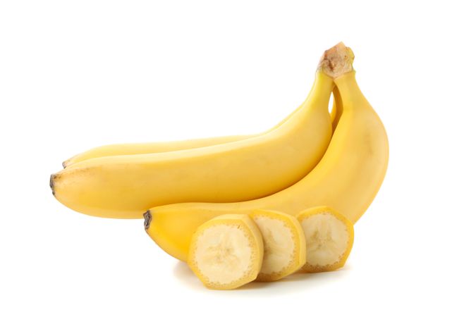 Banana cluster isolated on light background. Fresh fruit