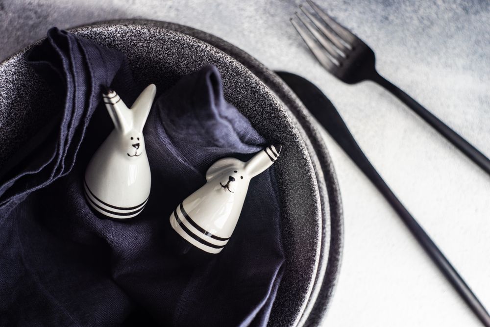 Rabbit figurines on table setting for Easter dinner