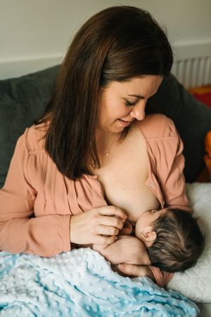 Mom breastfeeding at home