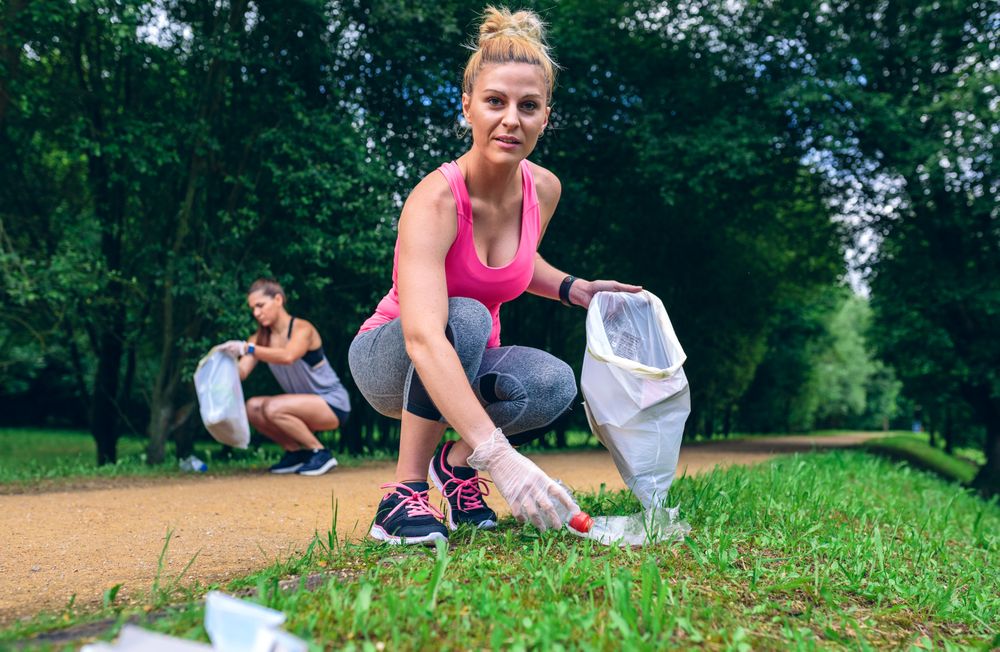 Woman picking up trash doing plogging