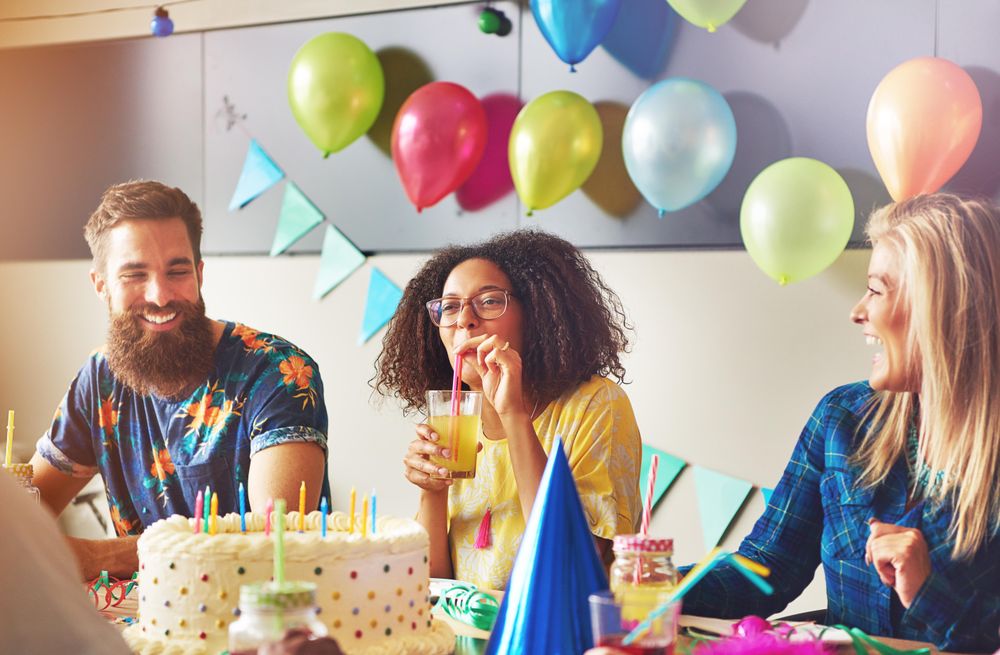 Male and female friends sitting at the birthday table