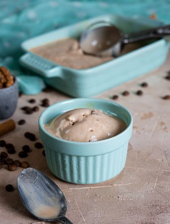 Coffee ice cream in ramekin with spoon
