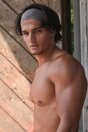 Muscular man posing in gym
