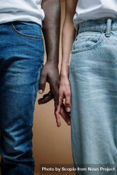 Two people in denim pants touching hands bEdx64