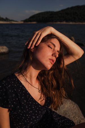 Sensual woman resting on lake shore