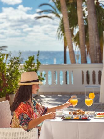 Woman eating on hotel terrace