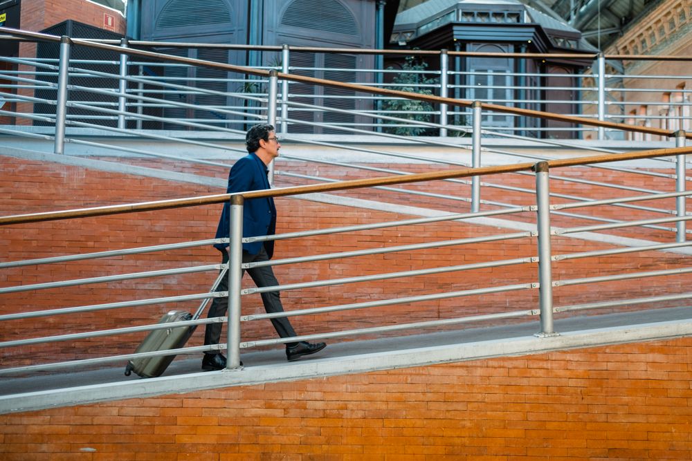Older traveler with baggage walking on ramp
