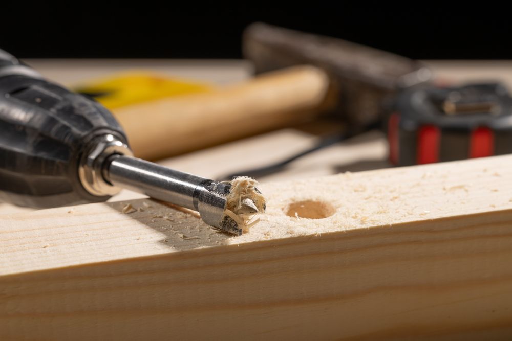 Macro drilled hole with drill and shavings