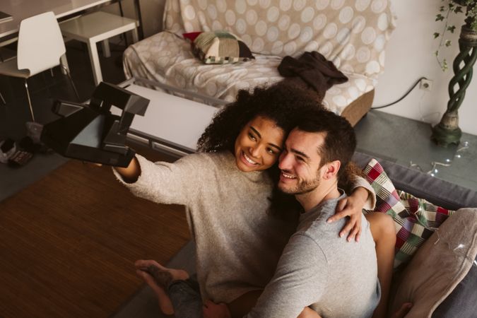 Couple taking selfie on couch
