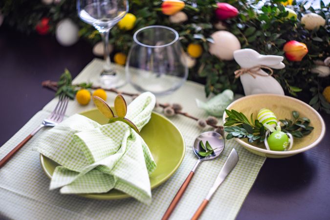Easter table setting with rabbit napkin ring on pastel green napkin