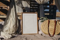 Blank picture frame, poster mockup in beach lounger, gazebo with canopy on beach resort