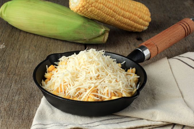 Cast iron pan for sweet corn and grated cheese