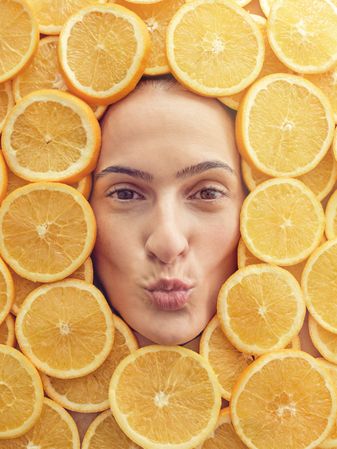 Female face with pouting lips in orange pieces