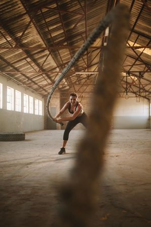Female athlete working out at empty warehouse