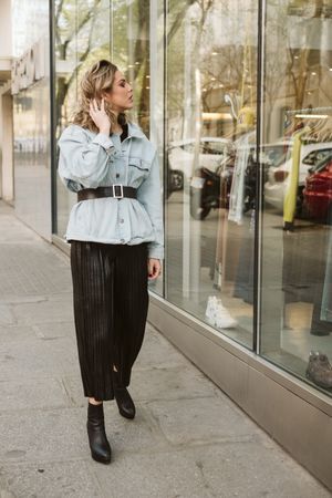 Trendy woman looking at shop window