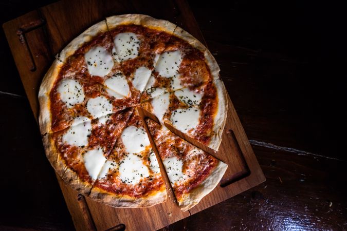 Freshly baked Italian pizza on wooden board