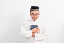Asian Muslim man holding quran during Ramadan