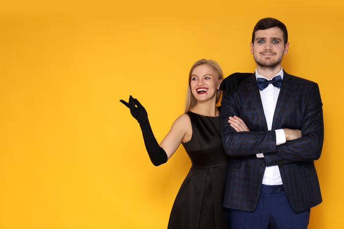 Concept of Halloween, young man and woman on yellow background