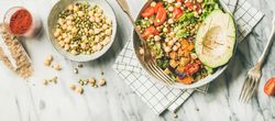 Healthy vegan lunch bowl with avocado, sprouted grains, vegetables, paprika, wide composition