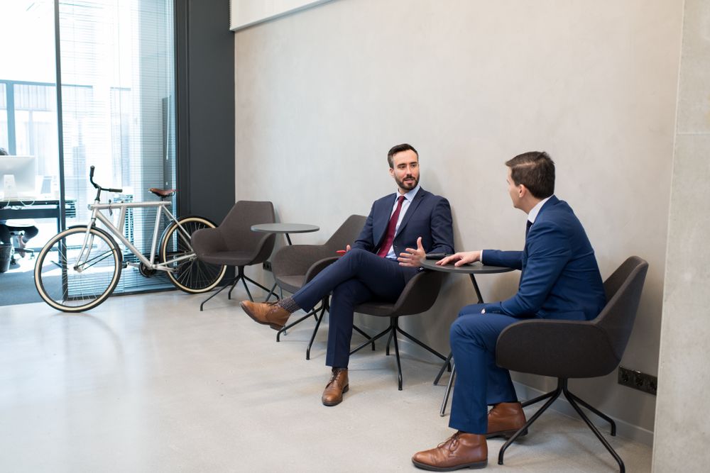 Trendy businessmen sharing knowledge