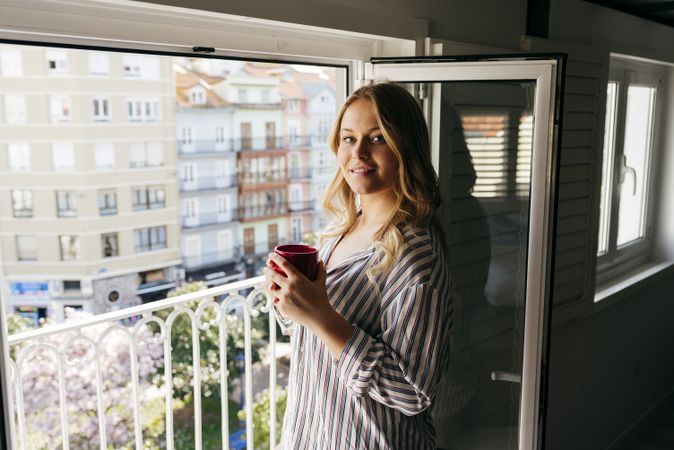Young woman with cup looking at camera