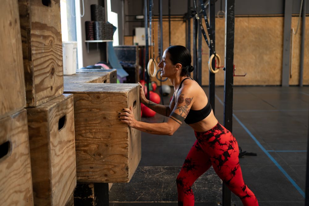 Woman in gym putting back box