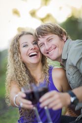 A Happy Couple With A Glass Of Wine in the Park
