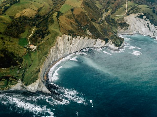 Sea waving near green hills