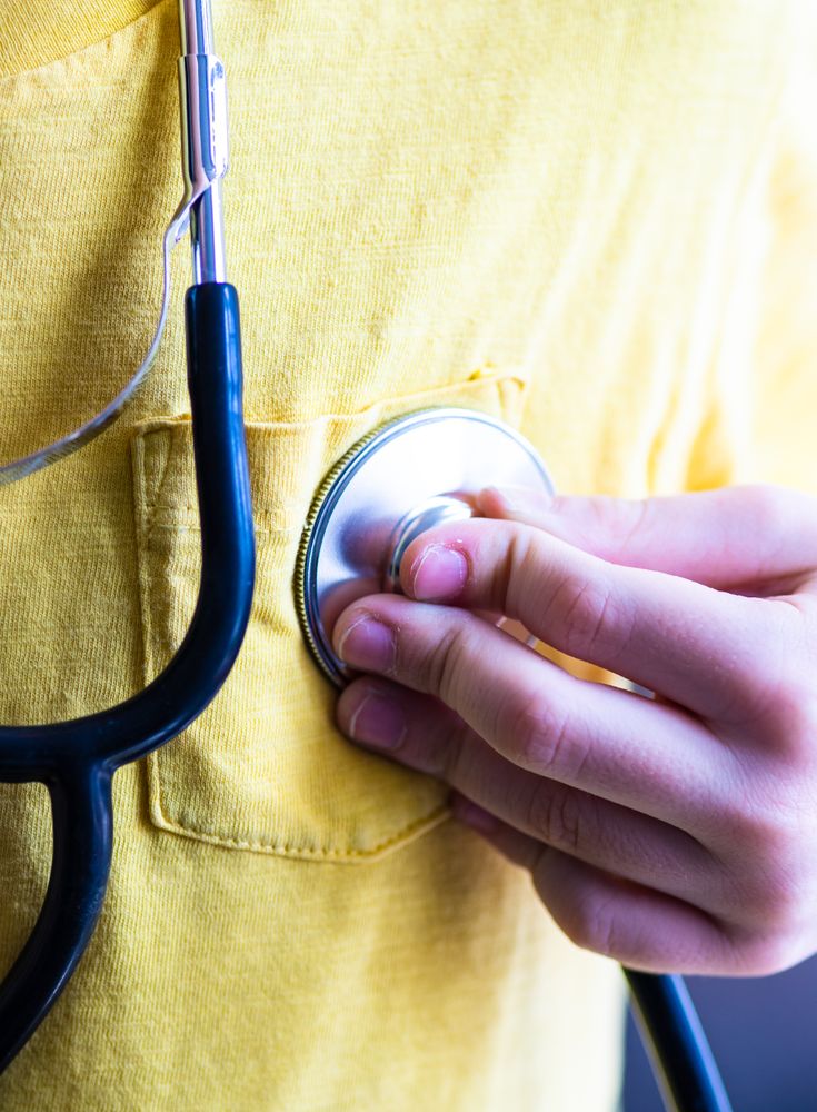 Person holding stethoscope to chest