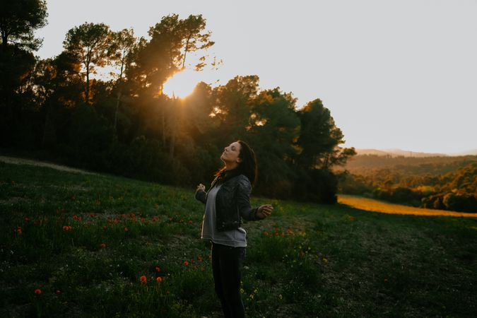 Woman walking on meadow and enjoying freedom