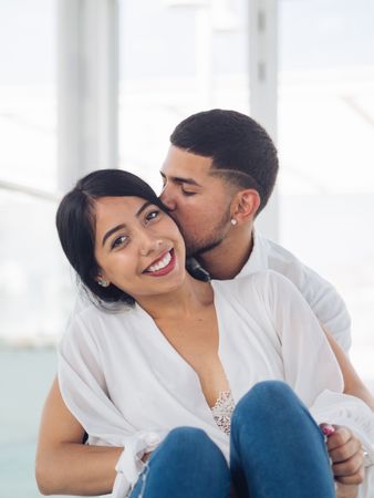 Man embracing smiling woman with love and tenderness