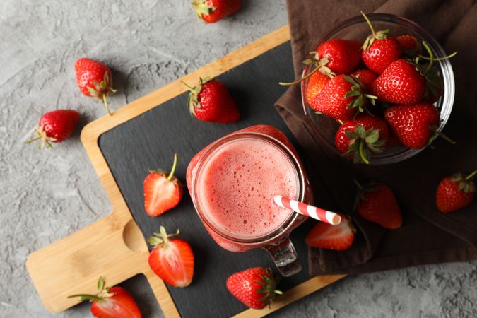 Composition with strawberry cocktail on gray table. Summer berry
