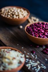 Three bowls of beans and grains