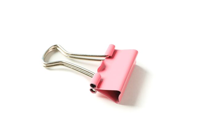 Color paper clip isolated on studio background