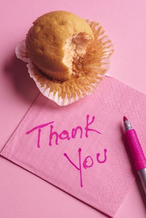 Thank you message hand-wrote on a pink napkin