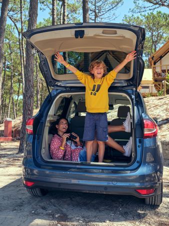 Laughing mother and son on summer road trip