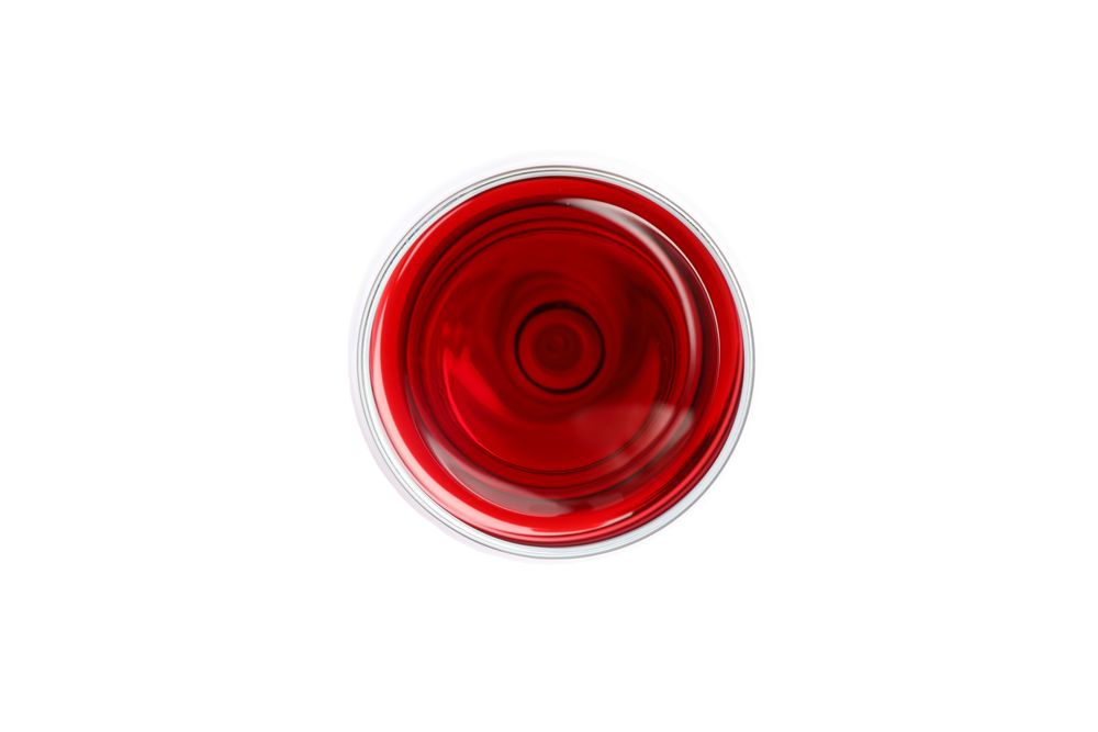 Glass with red wine isolated on blank background, top view